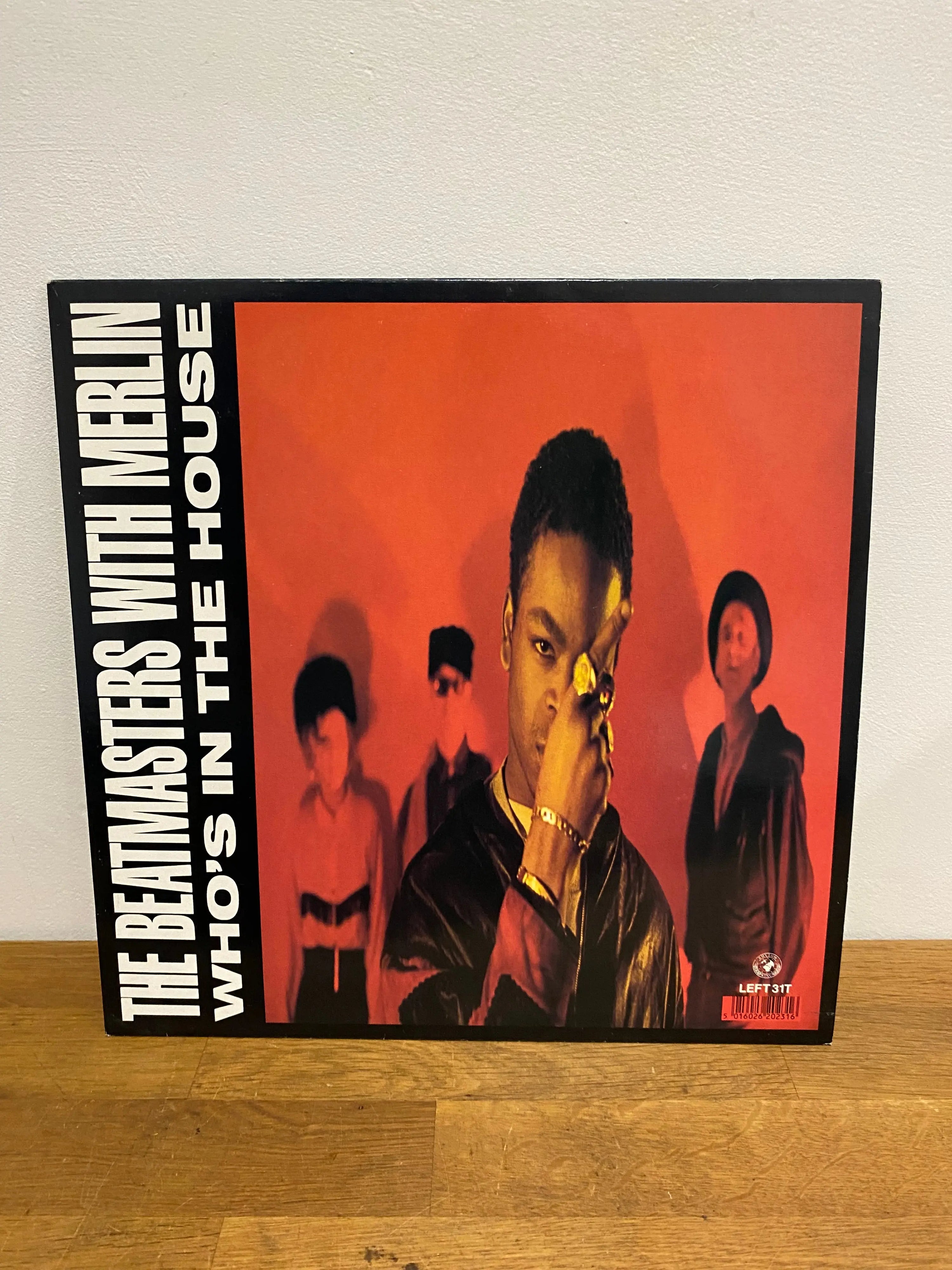 The Beatmasters with Merlin Who’s in the House 12 inch vinyl single front cover