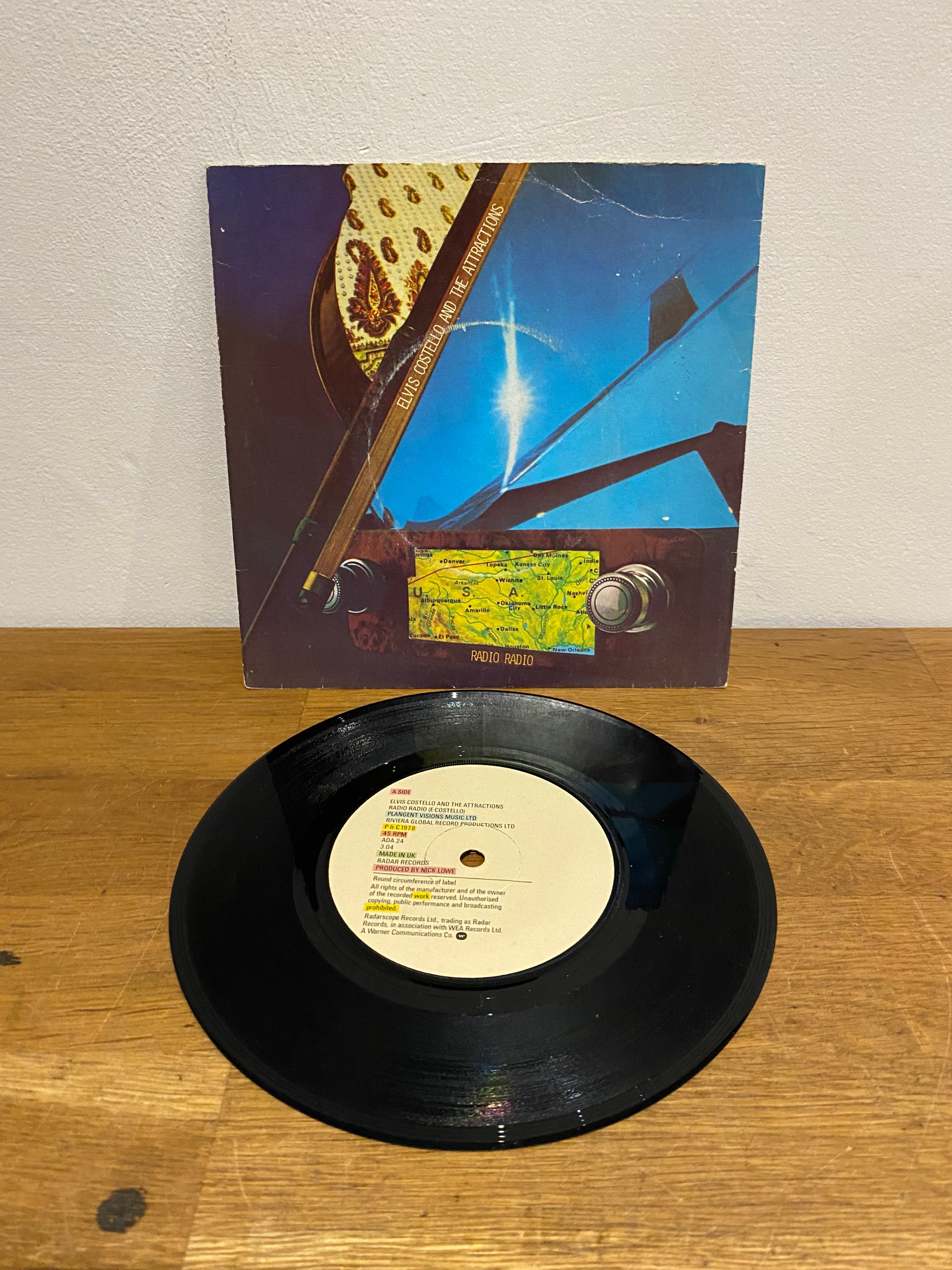 Elvis Costello & The Attractions - Radio Radio , 7” single, 1978 Radarscope records.