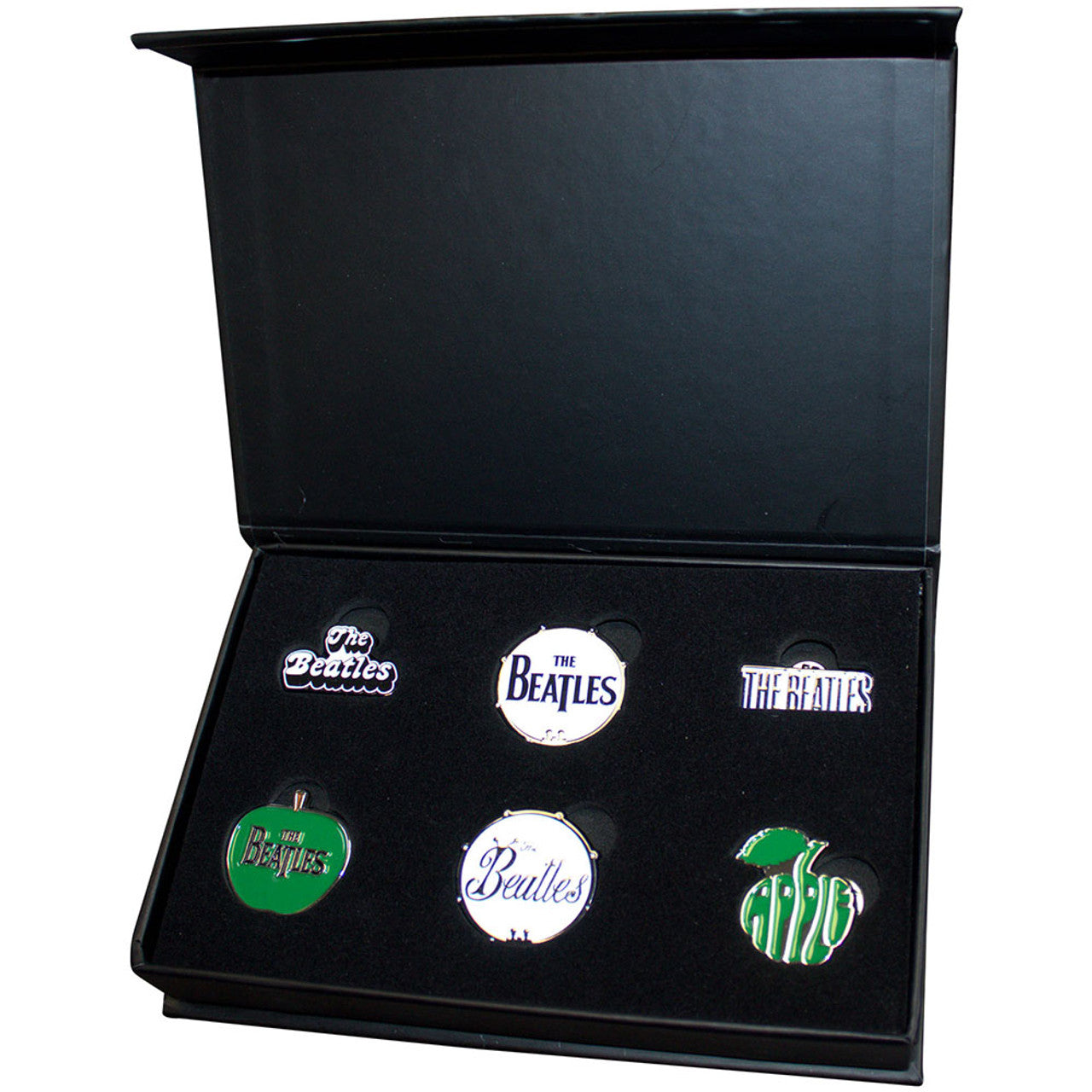 Close-up of The Beatles enamel logo pin badges with brass and soft enamel detailing – collectible gift for music fans.