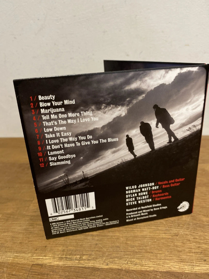 Back cover of Wilko Johnson's CD album with silhouette of band photo and tracklist 