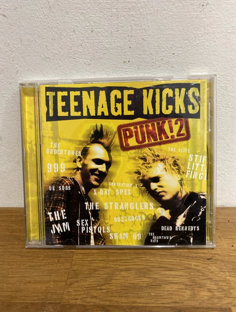 CD cover of 'Teenage Kicks Punk! 2' with two faces on a yellow background