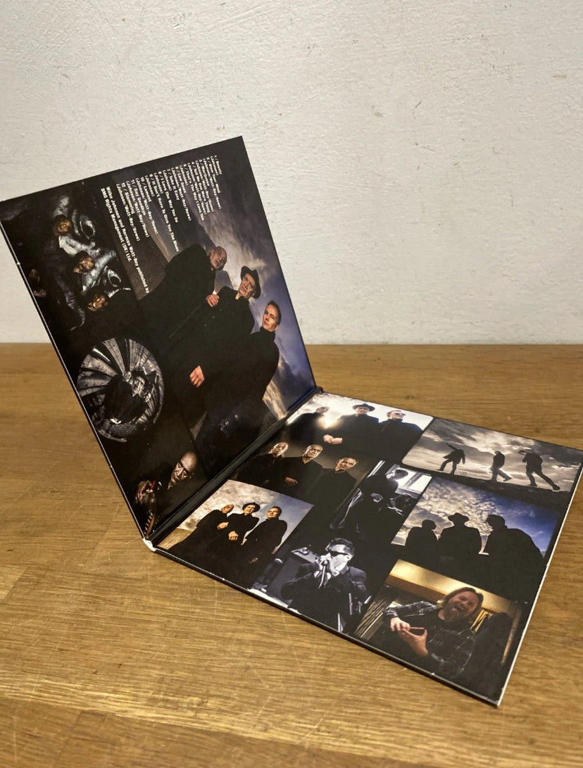 Open CD album cover with photos of the Wilko Johnson band on 